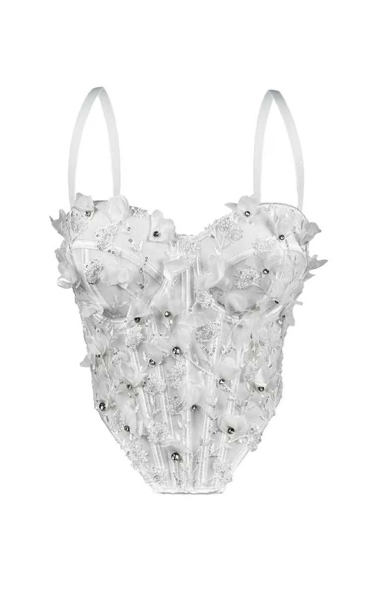 White top with floral and bead details on a white background