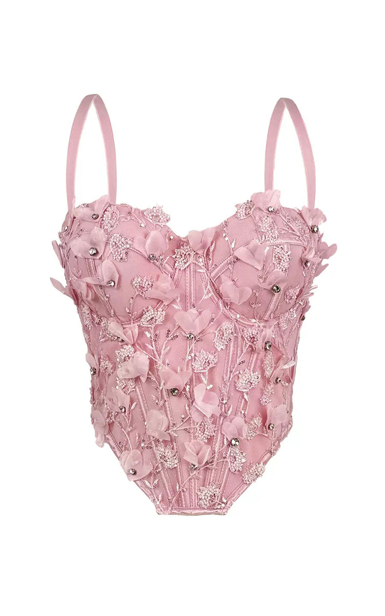 Pink embroidered top on a white background