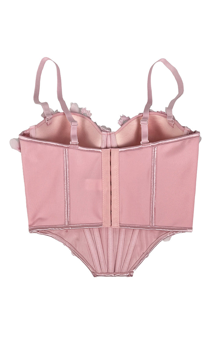 Pink corset-style top on a white background